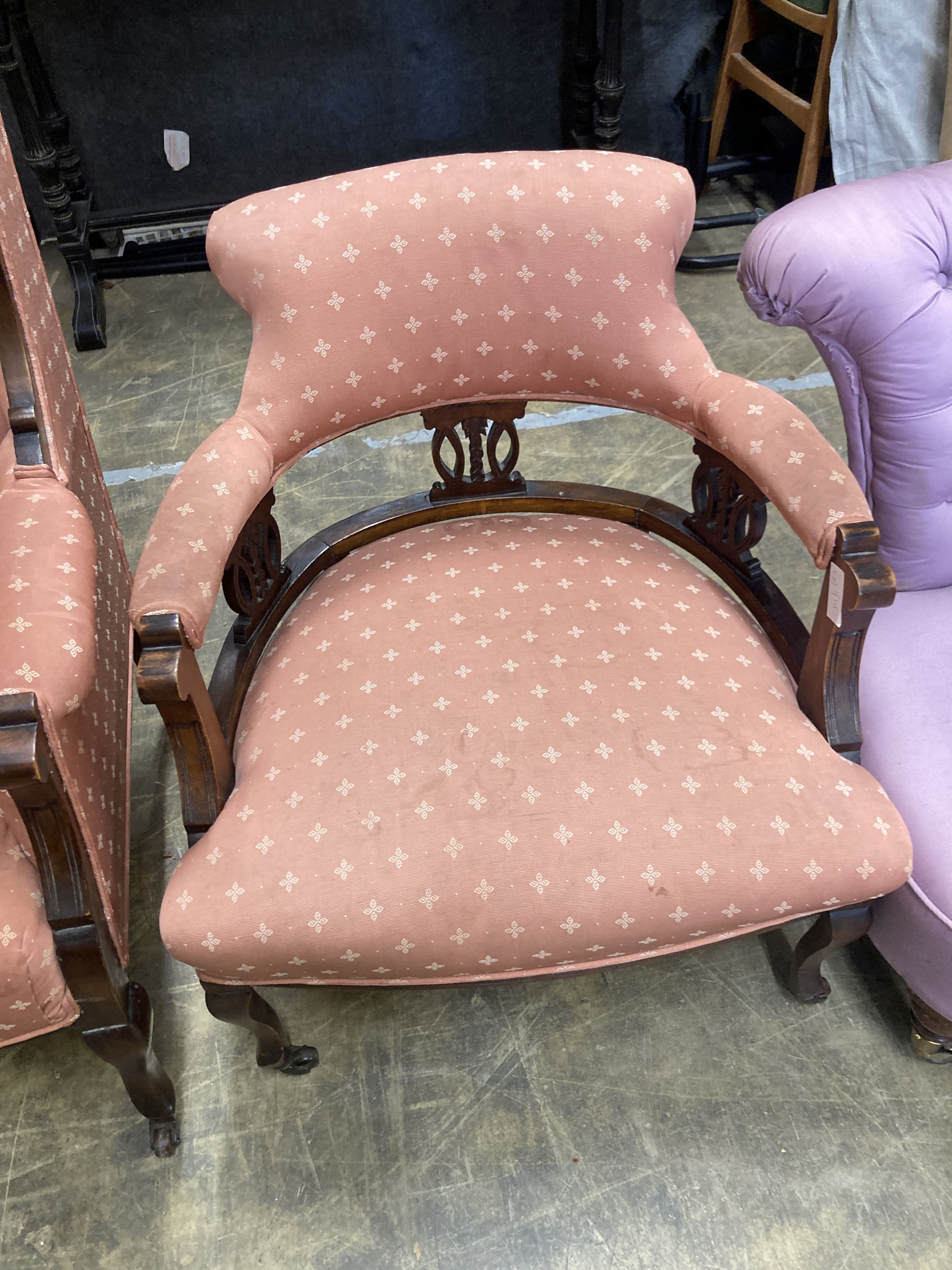 A late Victorian mahogany armchair together with a matching tub framed elbow chair